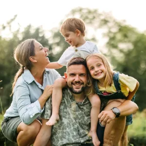 Family of four posing for the camera outside