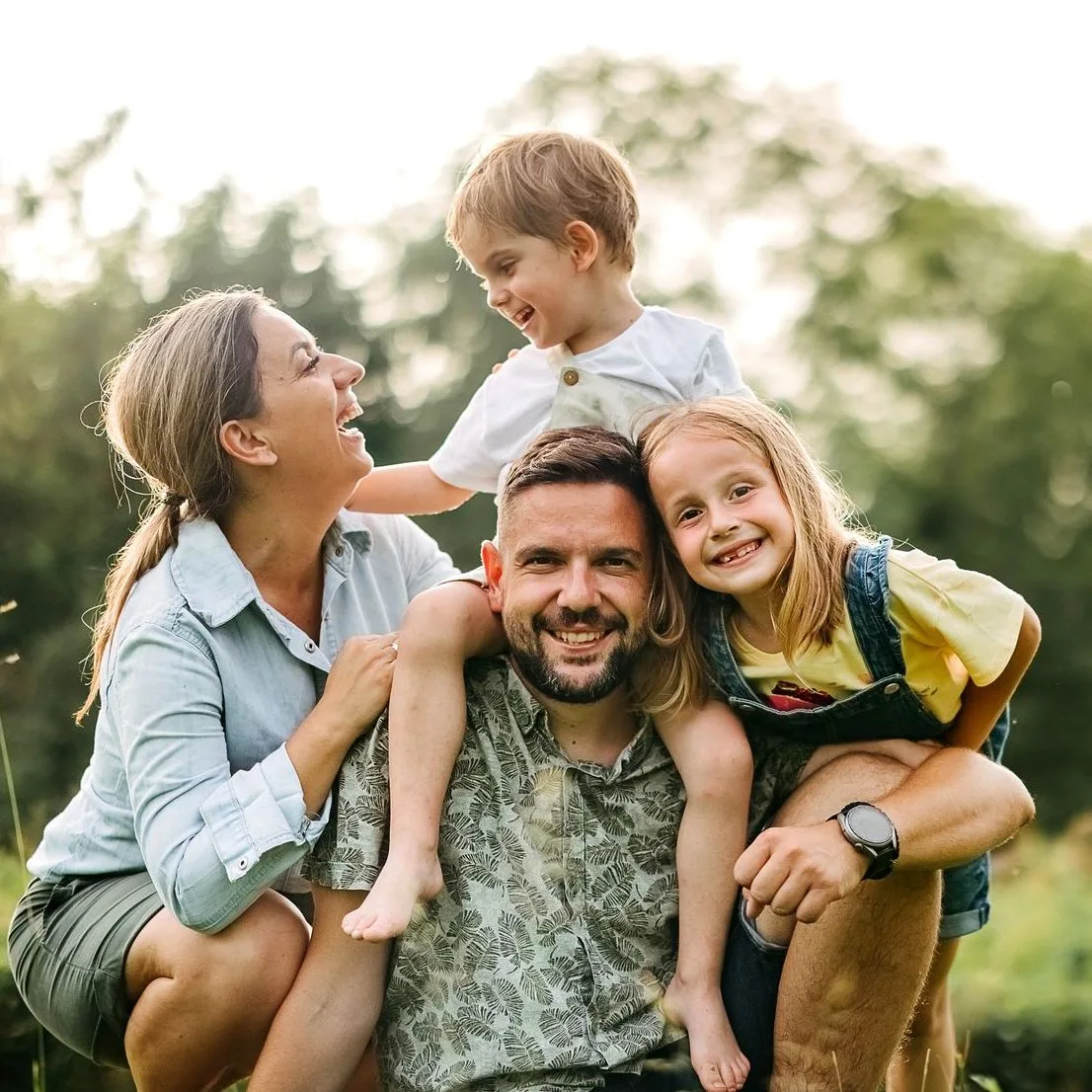 Family of four posing for the camera outside