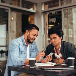 Business partners sitting at their cafe discussing business plans